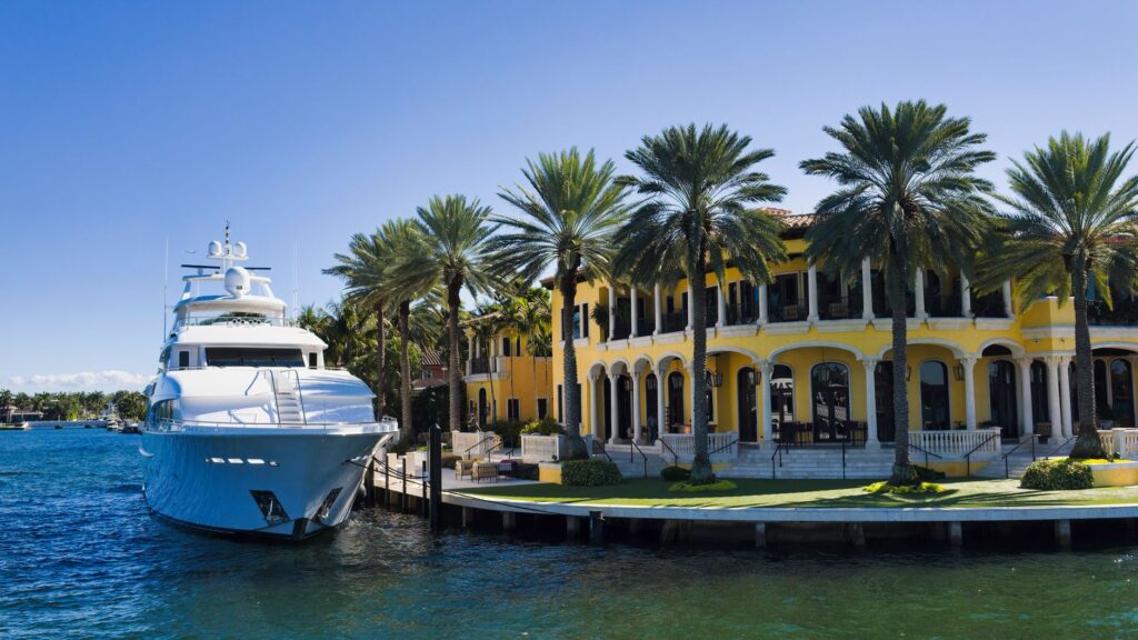 Motor yacht moored at the private dock of a waterfront estate