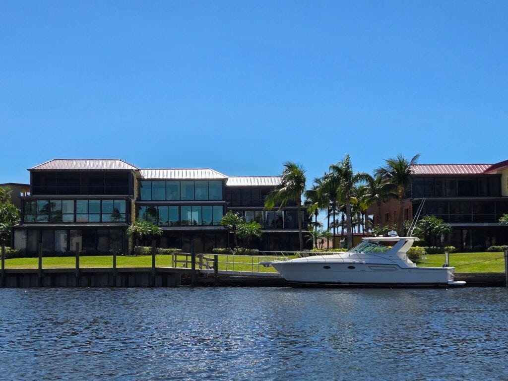 Modern waterfront residence with a yacht moored alongside