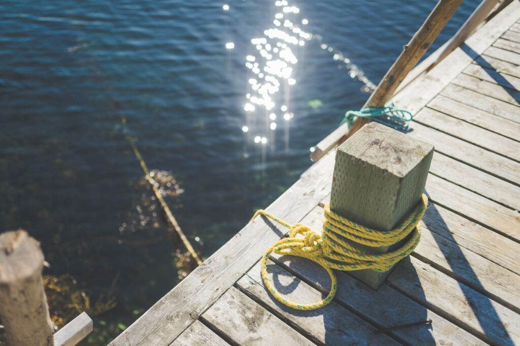 Mooring line coiled on the deck boards of a private dock